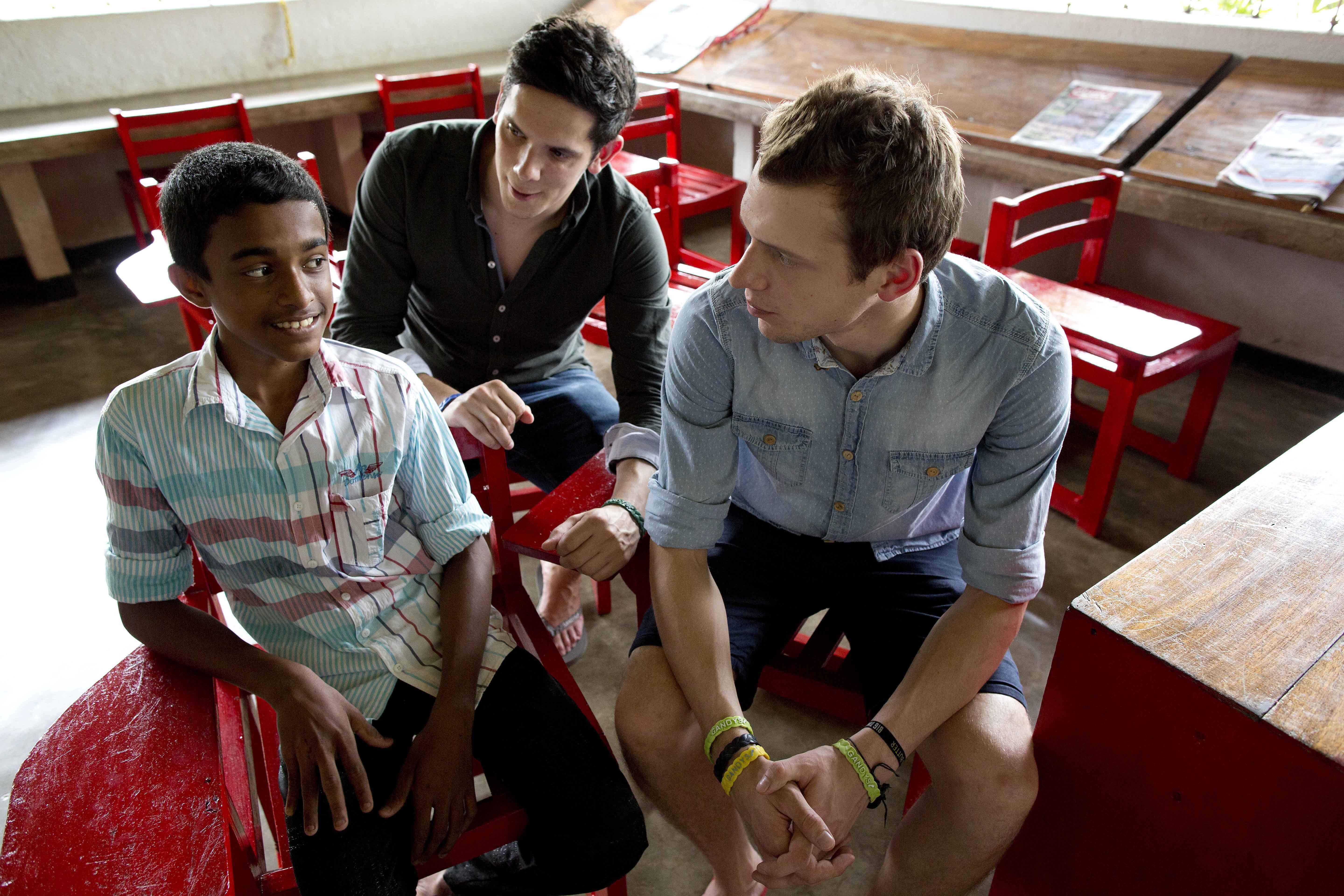 Paul (left) and Rob talking to a child at the kids campus in Sri Lanka.